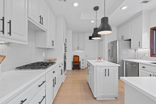 6302 Gato Path, Austin, TX 78731 - kitchen with stainless steel appliances, light countertops, white cabinetry, backsplash, and recessed lighting