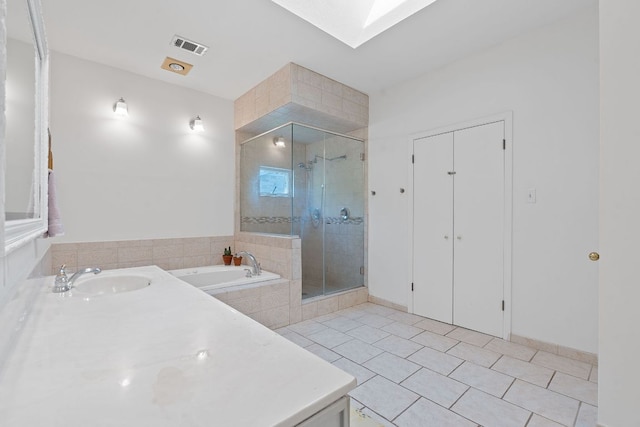 6302 Gato Path, Austin, TX 78731 - full bath with a garden tub, tile patterned flooring, a shower stall, a skylight, and vanity