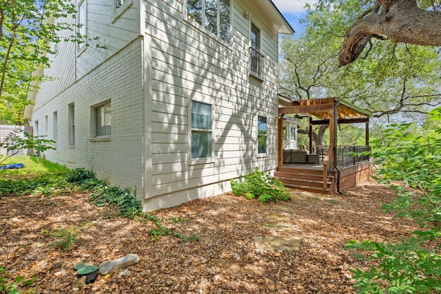 6302 Gato Path, Austin, TX 78731 - view of side of property featuring brick siding and a pergola