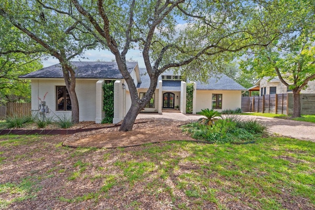 6302 Gato Path, Austin, TX 78731 - mid-century inspired home featuring french doors, brick siding, and roof with shingles