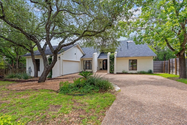 6302 Gato Path, Austin, TX 78731 - view of front of home with driveway, an attached garage, and a shingled roof