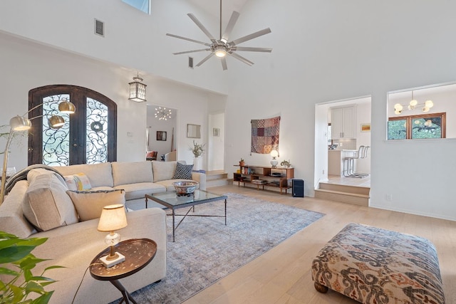 6302 Gato Path, Austin, TX 78731 - living room with arched walkways, a towering ceiling, french doors, light wood-style floors, and ceiling fan