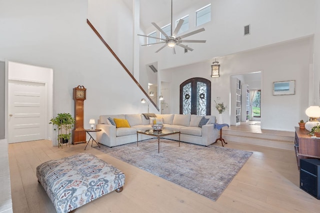 6302 Gato Path, Austin, TX 78731 - living room featuring wood finished floors, a high ceiling, ceiling fan, and french doors