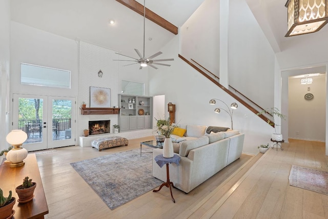 6302 Gato Path, Austin, TX 78731 - living area with high vaulted ceiling, light wood-type flooring, stairs, ceiling fan, and beam ceiling