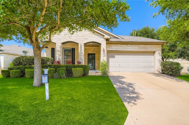 65 White Magnolia Cir, Lakeway, TX 78734 - view of front of home with stone siding, an attached garage, concrete driveway, and a front lawn