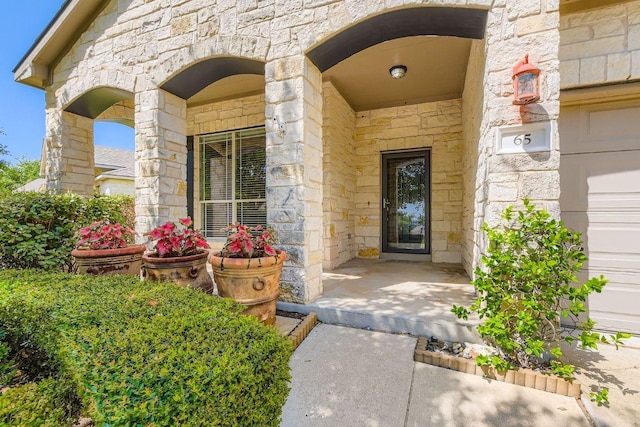 65 White Magnolia Cir, Lakeway, TX 78734 - view of exterior entry featuring stone siding and a porch