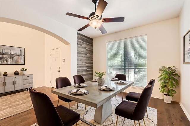 65 White Magnolia Cir, Lakeway, TX 78734 - dining room with arched walkways, ceiling fan, and wood finished floors