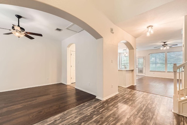 65 White Magnolia Cir, Lakeway, TX 78734 - unfurnished living room featuring ceiling fan, dark wood-style floors, and arched walkways