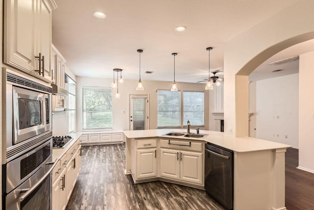 65 White Magnolia Cir, Lakeway, TX 78734 - kitchen featuring stainless steel appliances, dark wood finished floors, light countertops, a ceiling fan, and recessed lighting