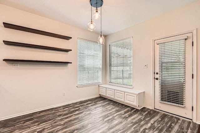 65 White Magnolia Cir, Lakeway, TX 78734 - unfurnished dining area with dark wood-style flooring and baseboards