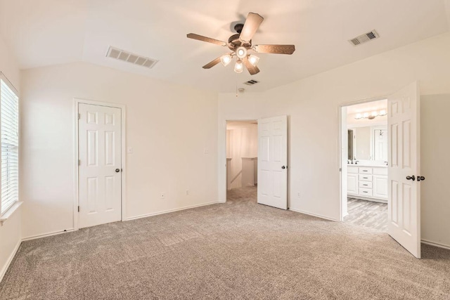 65 White Magnolia Cir, Lakeway, TX 78734 - unfurnished bedroom with light carpet, lofted ceiling, ensuite bath, and a ceiling fan
