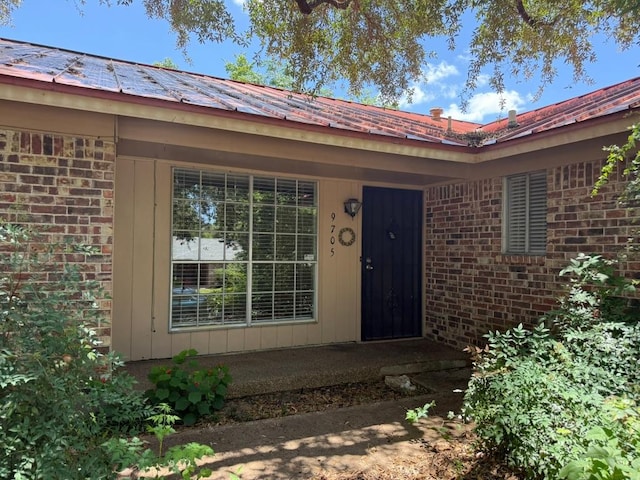9705 Marlborough Dr, Austin, TX 78753 - entrance to property featuring brick siding and a metal roof