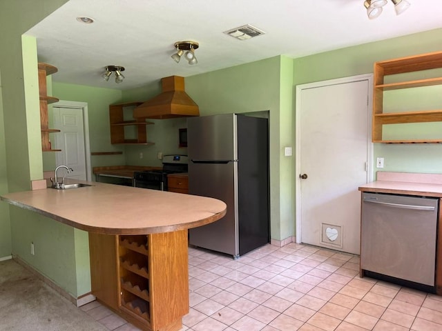 9705 Marlborough Dr, Austin, TX 78753 - kitchen with appliances with stainless steel finishes, open shelves, wall chimney range hood, a peninsula, and light countertops