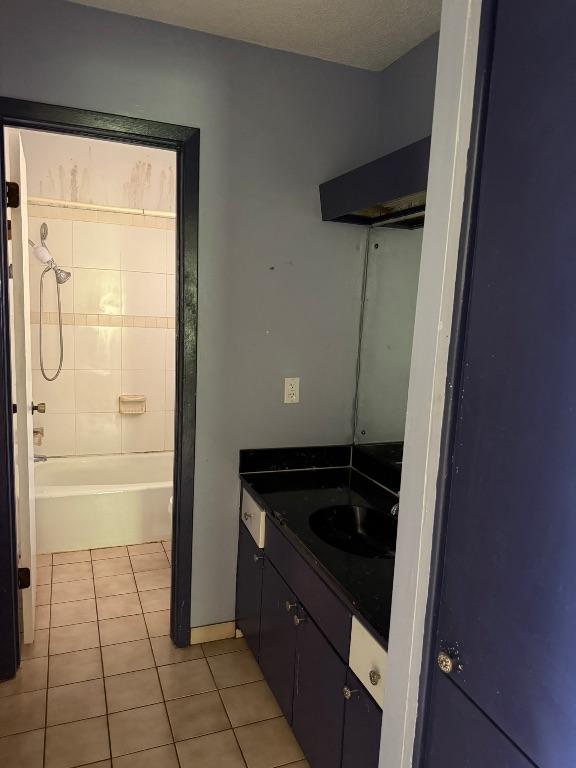 9705 Marlborough Dr, Austin, TX 78753 - bathroom featuring vanity, tile patterned flooring, and  shower combination