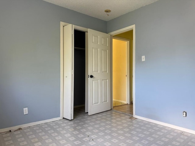 9705 Marlborough Dr, Austin, TX 78753 - unfurnished bedroom with a closet, a textured ceiling, and light flooring