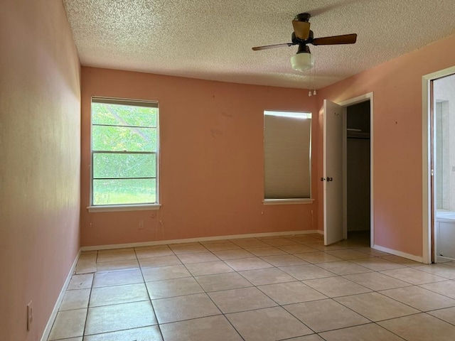 9705 Marlborough Dr, Austin, TX 78753 - unfurnished bedroom featuring a textured ceiling, light tile patterned floors, and ceiling fan
