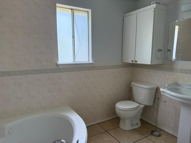 9705 Marlborough Dr, Austin, TX 78753 - bathroom featuring tile walls, a tub with jets, and tile patterned floors
