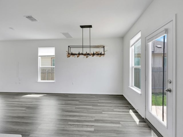 12416 Anthology St, Manor, TX 78653 - unfurnished dining area featuring wood finished floors and plenty of natural light