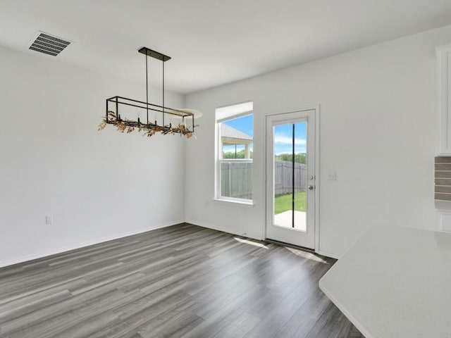 12416 Anthology St, Manor, TX 78653 - unfurnished dining area with wood finished floors and a chandelier