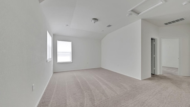 12416 Anthology St, Manor, TX 78653 - empty room with light carpet, vaulted ceiling, and attic access