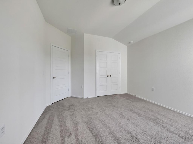 12416 Anthology St, Manor, TX 78653 - unfurnished bedroom with carpet floors, lofted ceiling, and a closet