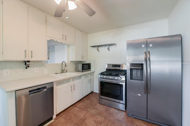 212 W 55th St, Austin, TX 78751 - kitchen with stainless steel appliances, light countertops, ceiling fan, and white cabinets