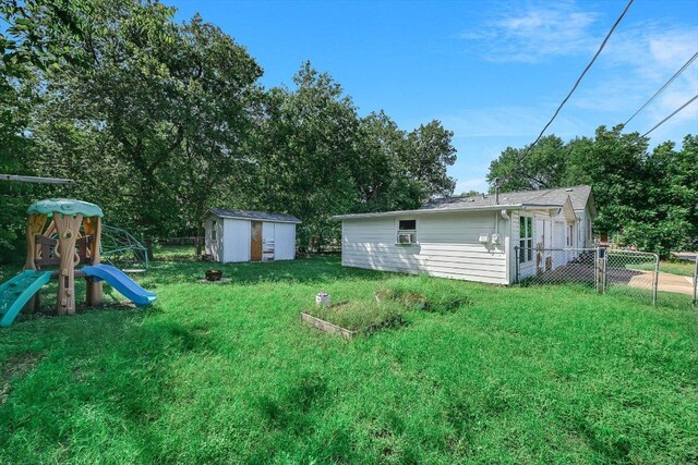 212 W 55th St, Austin, TX 78751 - view of yard featuring a storage shed and a playground