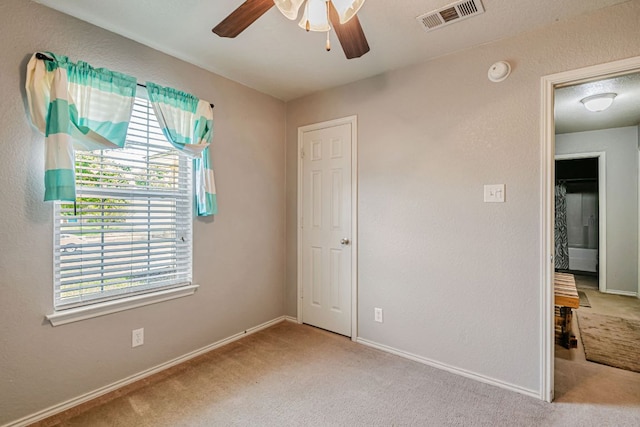4735 Stonehaven Dr, Temple, TX 76502 - unfurnished bedroom with carpet floors, multiple windows, and a ceiling fan