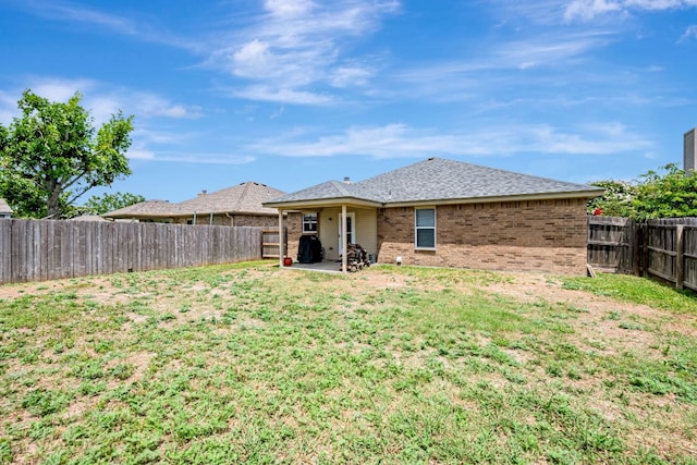 4735 Stonehaven Dr, Temple, TX 76502 - rear view of house with brick siding, a fenced backyard, and a patio