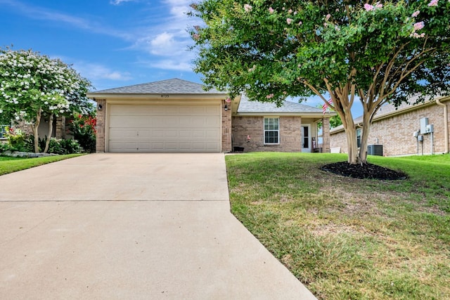 4735 Stonehaven Dr, Temple, TX 76502 - ranch-style house with brick siding, concrete driveway, a front lawn, and a garage