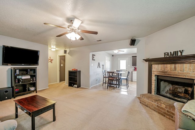 4735 Stonehaven Dr, Temple, TX 76502 - living area featuring a ceiling fan, light colored carpet, a textured ceiling, and a fireplace