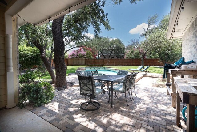 208 Norwood Cv, Georgetown, TX 78628 - fenced backyard featuring outdoor dining space and a patio area