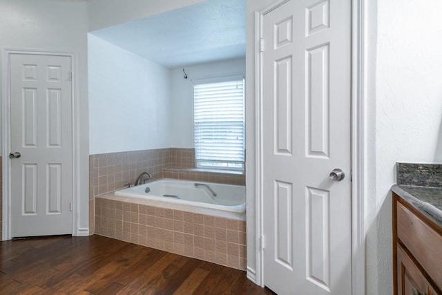 208 Norwood Cv, Georgetown, TX 78628 - bathroom with vanity, a bath, and wood finished floors