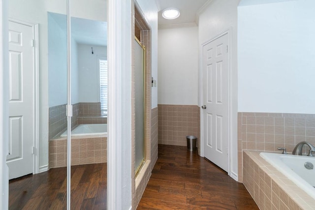 208 Norwood Cv, Georgetown, TX 78628 - full bath with wood finished floors, a bath, ornamental molding, a shower with shower door, and a wainscoted wall