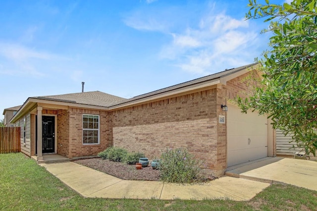 1326 Amy Dr, Kyle, TX 78640 - view of property exterior featuring an attached garage, brick siding, driveway, and a shingled roof