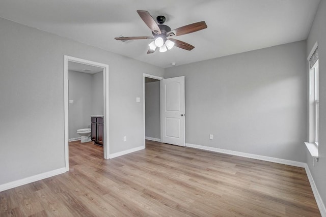 1326 Amy Dr, Kyle, TX 78640 - unfurnished bedroom with light wood-type flooring, ensuite bathroom, and a ceiling fan