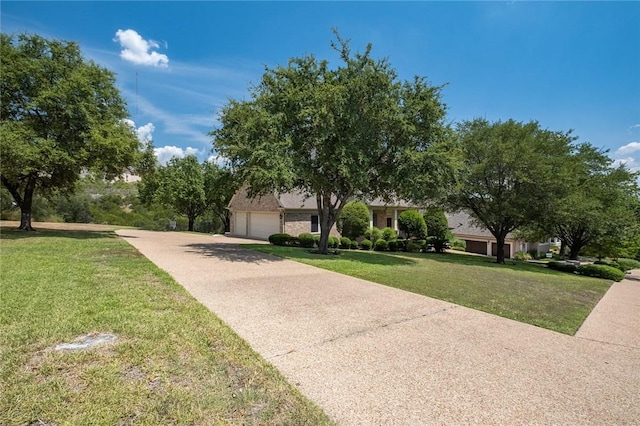 1733 Canonero Dr, Austin, TX 78746 - obstructed view of property with driveway, a front yard, and a garage