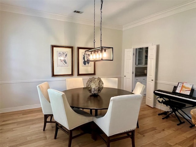 1733 Canonero Dr, Austin, TX 78746 - dining space featuring ornamental molding and light wood finished floors