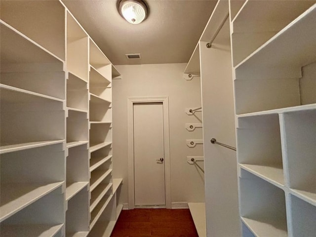 1733 Canonero Dr, Austin, TX 78746 - walk in closet featuring wood finished floors