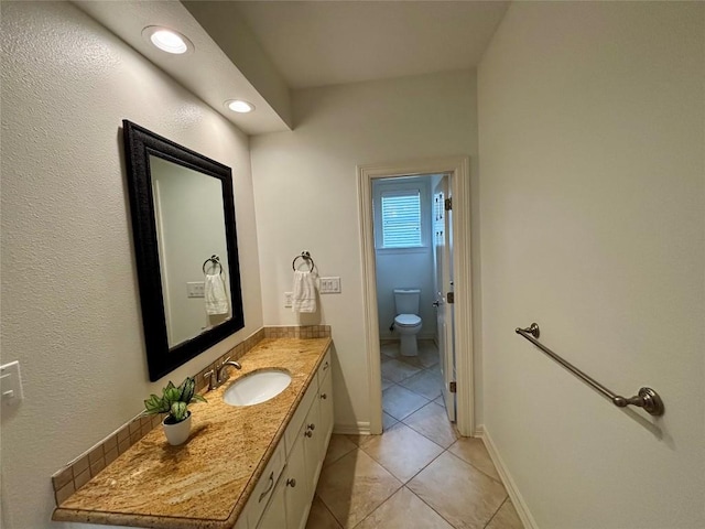 1733 Canonero Dr, Austin, TX 78746 - bathroom featuring tile patterned flooring, vanity, and recessed lighting