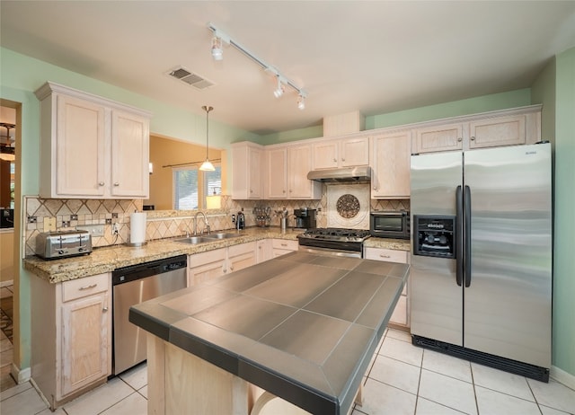 5102 Coppermead Ln, Austin, TX 78754 - kitchen with appliances with stainless steel finishes, under cabinet range hood, light tile patterned floors, and backsplash
