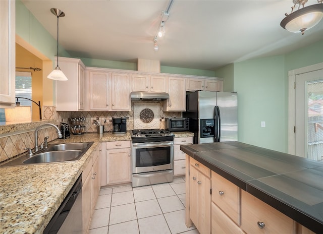 5102 Coppermead Ln, Austin, TX 78754 - kitchen with appliances with stainless steel finishes, under cabinet range hood, tasteful backsplash, light tile patterned flooring, and pendant lighting