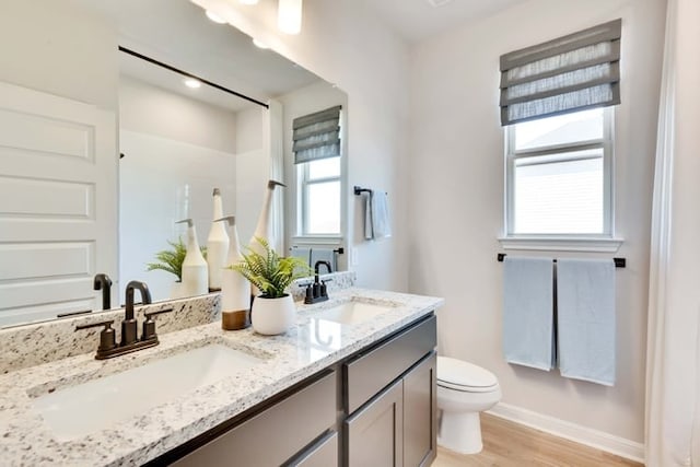6500 Smarty Jones Ln, Buda, TX 78610 - full bathroom featuring double vanity, wood finished floors, and a shower