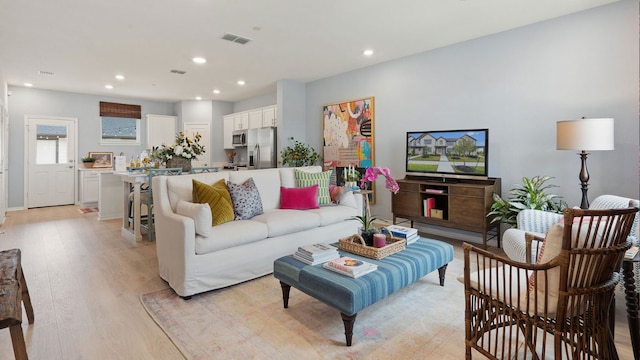 2528 Ophelia Levi Ln, Round Rock, TX 78665 - living room featuring light wood-type flooring and recessed lighting
