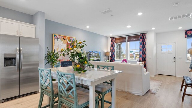 2528 Ophelia Levi Ln, Round Rock, TX 78665 - dining space with light wood-style flooring and recessed lighting