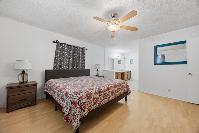 706 Cambridge Dr, Round Rock, TX 78664 - bedroom featuring wood finished floors, a textured ceiling, ensuite bath, and a ceiling fan