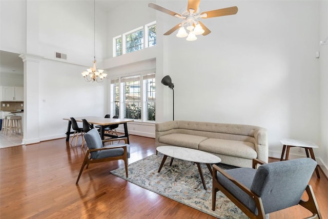 6100 Open Range Trl, Austin, TX 78749 - living room with wood finished floors, a chandelier, ceiling fan, and a high ceiling