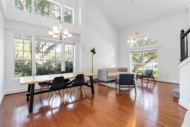 6100 Open Range Trl, Austin, TX 78749 - dining room featuring a towering ceiling, a chandelier, healthy amount of natural light, wood finished floors, and ornamental molding