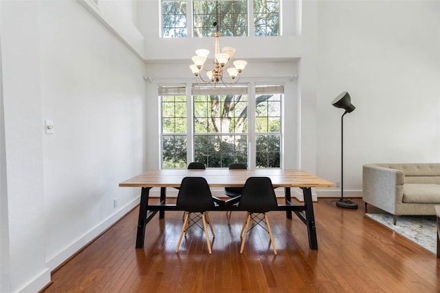 6100 Open Range Trl, Austin, TX 78749 - dining space featuring a chandelier, hardwood / wood-style floors, and a towering ceiling