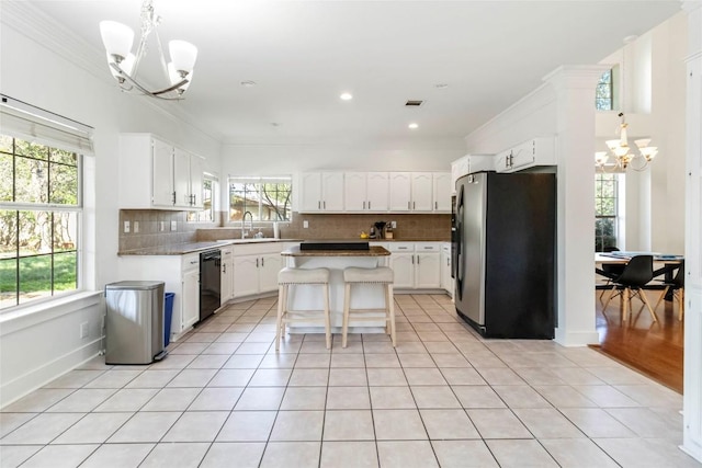 6100 Open Range Trl, Austin, TX 78749 - kitchen with freestanding refrigerator, a chandelier, dishwasher, decorative backsplash, and crown molding